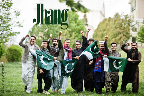 Jhang city. Group of pakistani man wearing traditional clothes with national flags. Biggest cities of Pakistan concept.