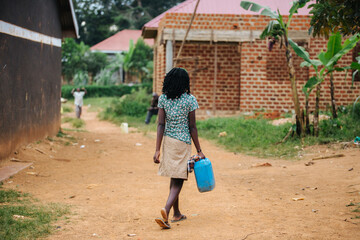 Woman carrying water in Uganda, Africa