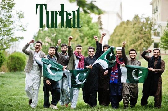 Turbat city. Group of pakistani man wearing traditional clothes with national flags. Biggest cities of Pakistan concept.