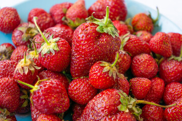 Red juicy strawberries on a plate
