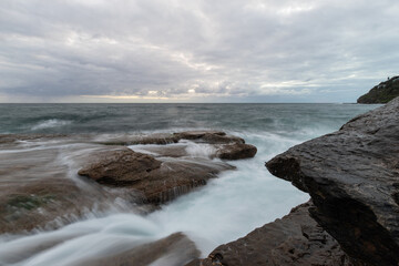 Water flowing on the rock at the coastline.