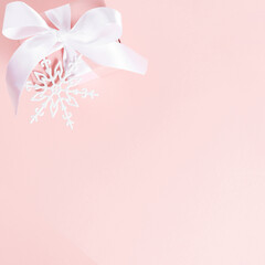 Christmas, winter composition. Xmas white decorations, gift box with ribbon, snowflakes on pastel pink background. Christmas, New Year, winter concept. Flat lay, top view, copy space