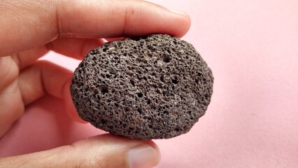 Oxide pumice speciment, brown, rounded and weighs light , is a volcanic rock that consists of...