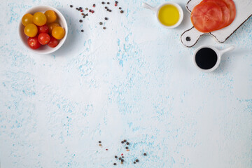Fresh food products and vegetables and spices on a blue background.
