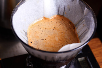Coffee powder in paper filter. Coffee funnel, coffee filter, how to brew coffee correctly. Proper brewing of specialty coffee