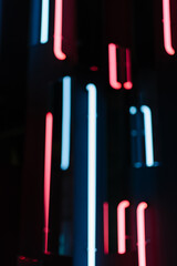 Blurred neon lamps glow red and blue. Abstract light of photo zone defocused