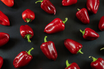 Red peppers on black background