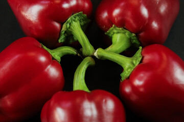 Red peppers on black background