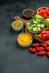 side view of plate stand with vegetables over and near to it and free place for your text on dark grey background