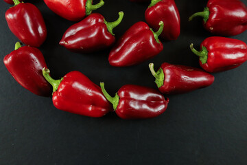 Red peppers on black background