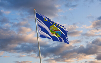 Montana US State Flag at sky background.