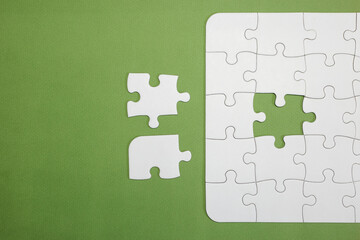 incomplete puzzle with one piece missing to complete it. there are two pieces next to each other but only one of them is the right one. business, teamwork, choosing. copy space