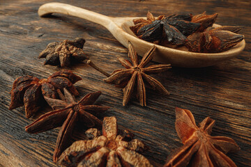 Macro photo of anise stars on wooden background