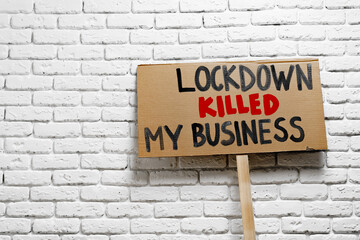 Fototapeta na wymiar Protestive placard against coronavirus lockdowns against grey background