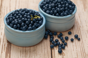 Bilberries on white wooden board background. Healthy eating