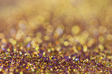 blurred sparkling gold glitter light as abstract festive background for website banner and card decoration