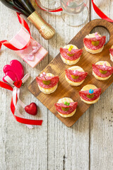 Valentines day or birthday romantic snacks. Canapes with bread, cheese, salami and olives. Flat top view. Copy space.