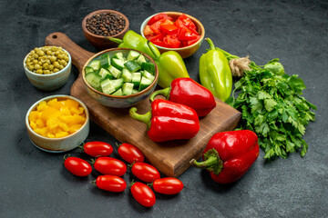 side close view of plate stand with vegetables over and near to it on dark grey background