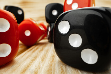 Red and black dice cubes on wooden background
