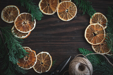Christmas banner with dried oranges and evergreens, a copy space in the center
