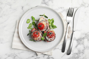 Baked eggplant with tomatoes, cheese and basil served on white marble table, flat lay