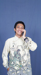 asian man calling happy expression with batik clothes