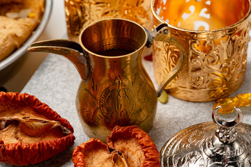 Arabic metal dishware and dry fruits on table
