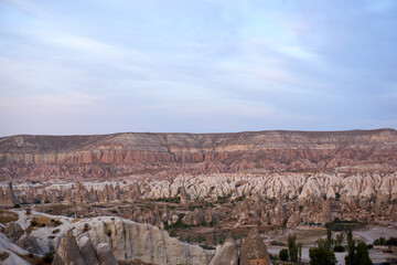 Ancient cave houses  and rock formations near Goreme, Cappadocia, Turkey