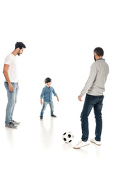 Naklejka premium hispanic father and granddad playing football with kid on white, three generations of men