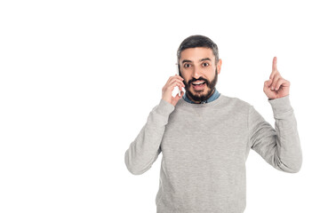 Fototapeta premium excited hispanic man showing idea gesture while talking on smartphone isolated on white