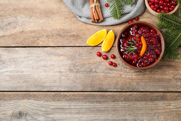 Flat lay composition with cranberry sauce on wooden table, space for text