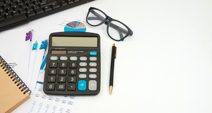 Business accounter working with documents and calculator on white office desk