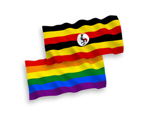 National vector fabric wave flags of Rainbow gay pride and Uganda isolated on white background. 1 to 2 proportion.