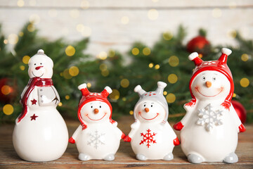 Funny little snowmen on wooden table. Christmas decor