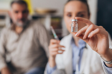 close up of doctor holding vaccine