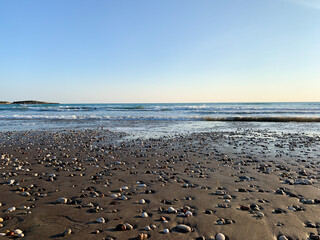 Sand beach with some pebbles and se view background