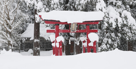 Naklejka premium 豪雪地帯の冬（雪に覆われた神社の鳥居）