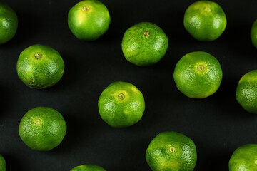 Green sweet tangerines growing with background