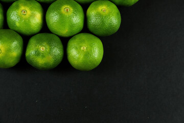 Green sweet tangerines growing with background