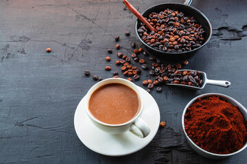 .Roasted coffee beans with coffee powder and coffee cups.