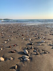Fototapeta na wymiar Sand beach with some pebbles and se view background