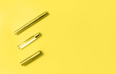 Flat lay composition with decorative makeup products and parfume toned in trendy yellow. Makeup and beaty concept. Color 2021 concept.