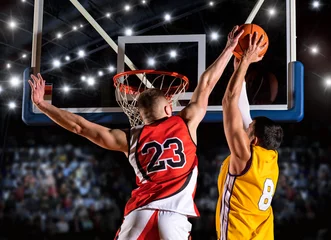 Foto op Plexiglas Two basketball players in arena. Blocked shot © Andrey Burmakin