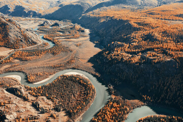 Autumn mountain valley, crankle curve blue river, orange and green forest. Aerial drone  view