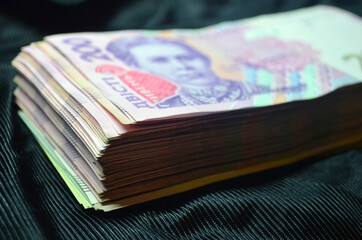 Large amount of money. Currency of Ukraine. Stack. Finance. Stocks, credit, debt.