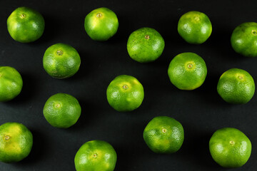 Green sweet tangerines growing with background