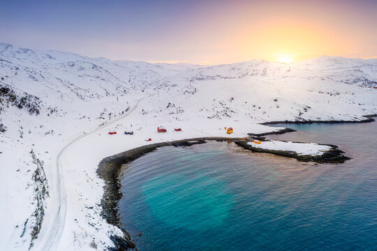 Snowy road towards the fishing village of Breivikbotn at sunset, Soroya Island, Hasvik, Troms og Finnmark