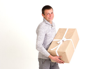 Handsome smiling man with big gift on white background