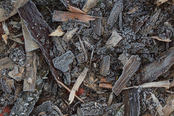 The slivers of wood on the ground covered with snow cover 