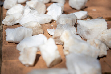 white quartz stones for the sauna lie on the tiles dry after cleaning